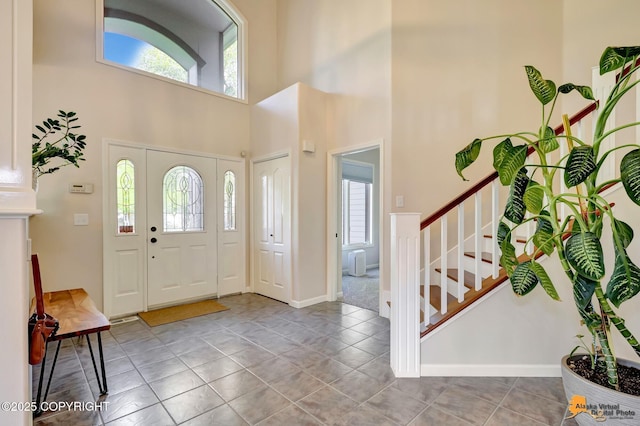 740 Botanical Heights Cir, Anchorage, AK 99515 - entryway with plenty of natural light, a high ceiling, stairway, and baseboards