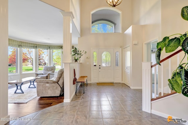 740 Botanical Heights Cir, Anchorage, AK 99515 - foyer entrance with healthy amount of natural light, decorative columns, baseboards, a high ceiling, and a chandelier
