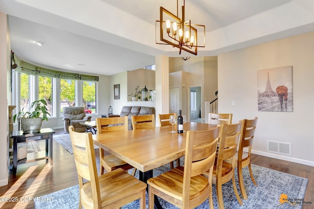 740 Botanical Heights Cir, Anchorage, AK 99515 - dining space featuring wood finished floors, stairway, baseboards, and a chandelier