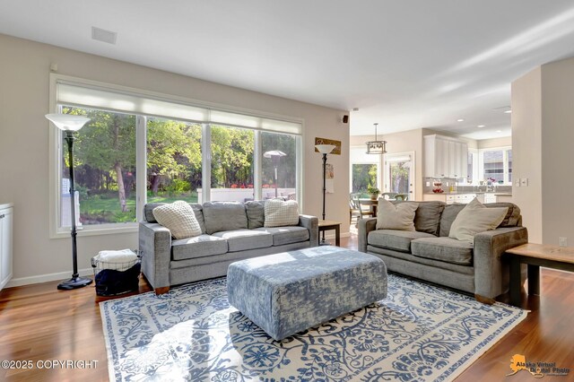 740 Botanical Heights Cir, Anchorage, AK 99515 - living area with wood finished floors, baseboards, and recessed lighting