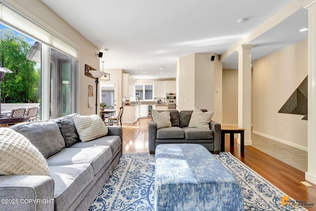 740 Botanical Heights Cir, Anchorage, AK 99515 - living room with light wood finished floors and ornate columns