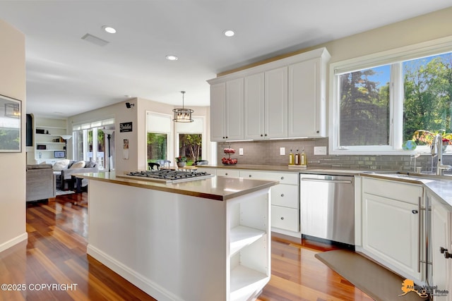 740 Botanical Heights Cir, Anchorage, AK 99515 - kitchen featuring stainless steel appliances, white cabinetry, light wood-style floors, tasteful backsplash, and recessed lighting