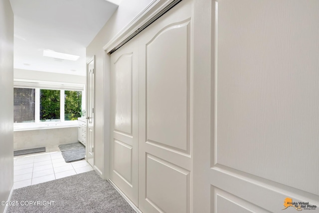 740 Botanical Heights Cir, Anchorage, AK 99515 - hallway featuring light colored carpet and light tile patterned floors