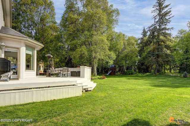 740 Botanical Heights Cir, Anchorage, AK 99515 - view of grassy yard with a deck and view of wooded area