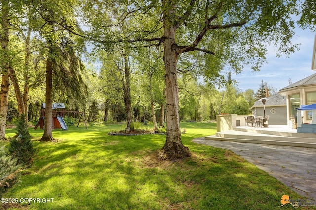740 Botanical Heights Cir, Anchorage, AK 99515 - view of green lawn with a playground and a wooden deck
