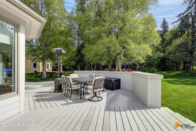 740 Botanical Heights Cir, Anchorage, AK 99515 - wooden deck with outdoor dining area, a yard, and view of scattered trees
