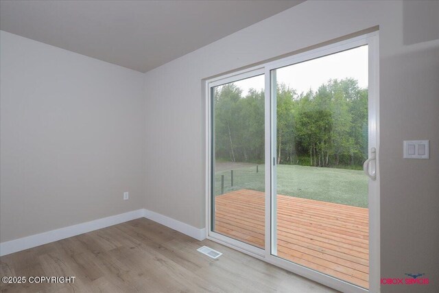 9089 E Spring Creek Cir, Palmer, AK 99645 - spare room featuring wood finished floors and baseboards