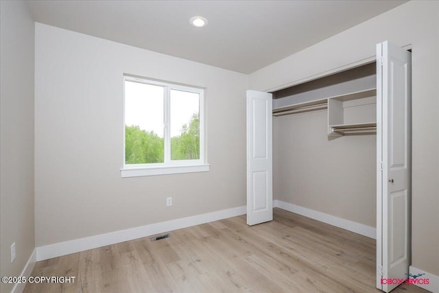 9089 E Spring Creek Cir, Palmer, AK 99645 - unfurnished bedroom with wood finished floors, baseboards, recessed lighting, and a closet