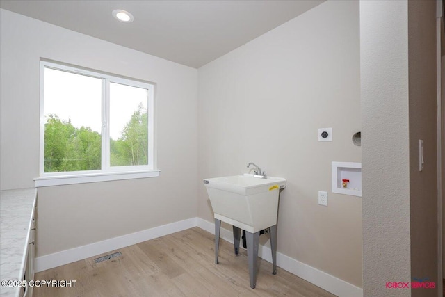9089 E Spring Creek Cir, Palmer, AK 99645 - washroom with hookup for an electric dryer, light wood-style flooring, baseboards, and washer hookup