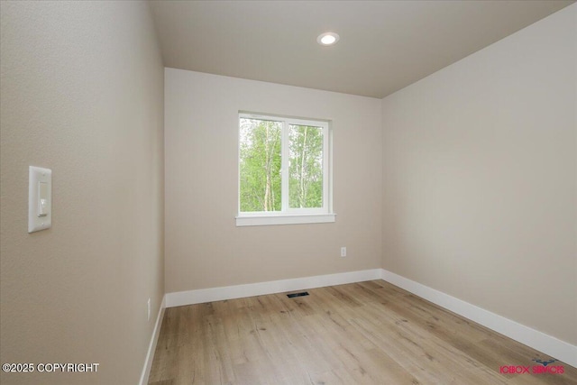 9089 E Spring Creek Cir, Palmer, AK 99645 - unfurnished room featuring baseboards, light wood-style floors, and recessed lighting