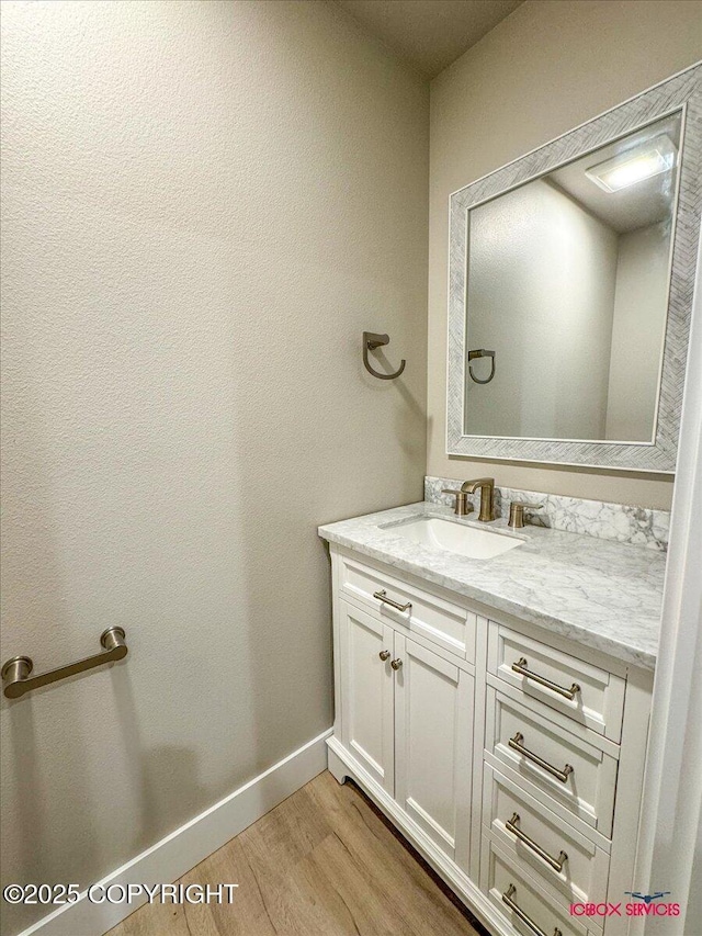 9089 E Spring Creek Cir, Palmer, AK 99645 - bathroom featuring wood finished floors, vanity, and baseboards