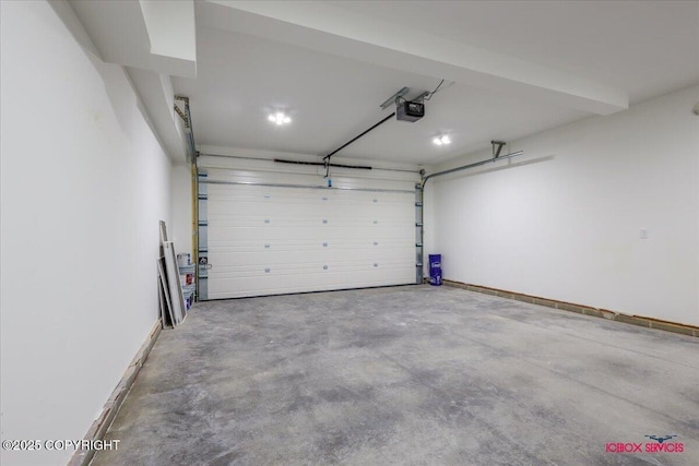 9089 E Spring Creek Cir, Palmer, AK 99645 - garage featuring a garage door opener and baseboards