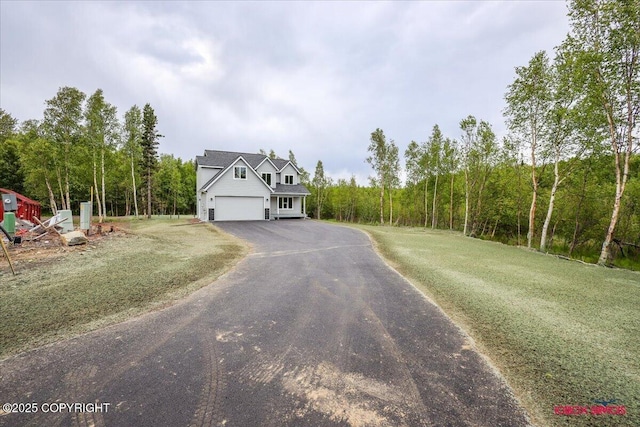 9089 E Spring Creek Cir, Palmer, AK 99645 - view of front of property featuring asphalt driveway, a front yard, and a view of trees