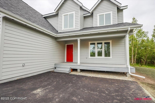 9089 E Spring Creek Cir, Palmer, AK 99645 - view of front facade featuring covered porch and a shingled roof