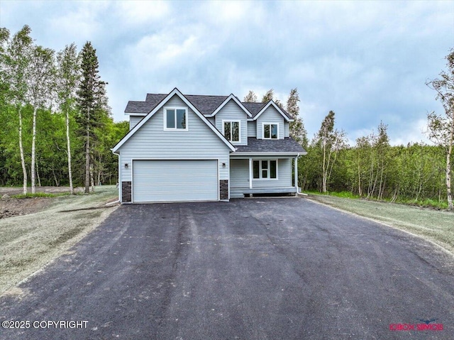 9089 E Spring Creek Cir, Palmer, AK 99645 - traditional home featuring asphalt driveway, roof with shingles, and a garage