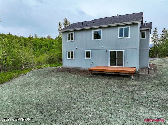 9089 E Spring Creek Cir, Palmer, AK 99645 - rear view of house with a wooden deck and a shingled roof