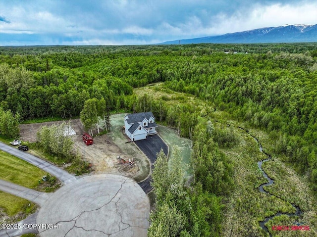 9089 E Spring Creek Cir, Palmer, AK 99645 - aerial view of property and surrounding area with a heavily wooded area