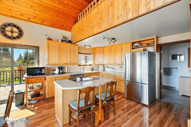 5301 N Glacier View Ct, Homer, AK 99603 - kitchen with freestanding refrigerator, black microwave, cooktop, baseboard heating, and light countertops