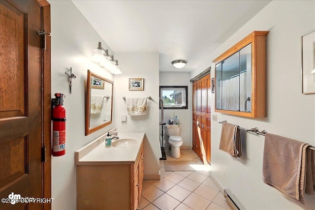 5301 N Glacier View Ct, Homer, AK 99603 - full bathroom with tile patterned floors, vanity, toilet, and a baseboard radiator