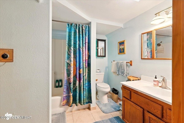 5301 N Glacier View Ct, Homer, AK 99603 - bathroom featuring tile patterned floors, vanity, toilet, shower / tub combo with curtain, and a textured wall