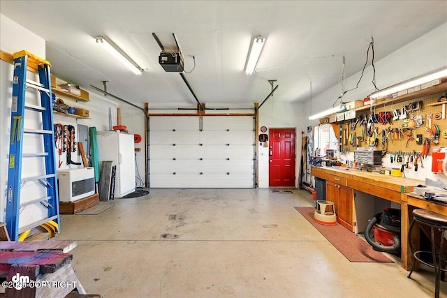5301 N Glacier View Ct, Homer, AK 99603 - garage with a garage door opener and a workshop area