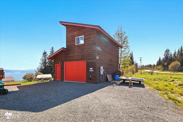 5301 N Glacier View Ct, Homer, AK 99603 - view of property exterior with gravel driveway and a garage
