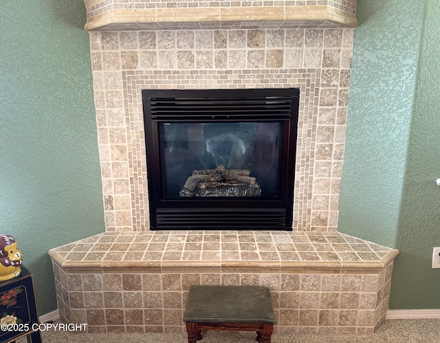17110 E Kathy Cir, Palmer, AK 99645 - detailed view of a glass covered fireplace, baseboards, and a textured wall
