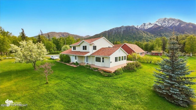 17110 E Kathy Cir, Palmer, AK 99645 - view of front facade with a mountain view and a front lawn