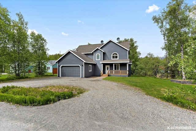 1675 E Pintail Dr, Wasilla, AK 99645 - view of front of property with covered porch, an attached garage, driveway, a front yard, and roof with shingles