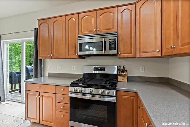1675 E Pintail Dr, Wasilla, AK 99645 - kitchen featuring stainless steel appliances and brown cabinets