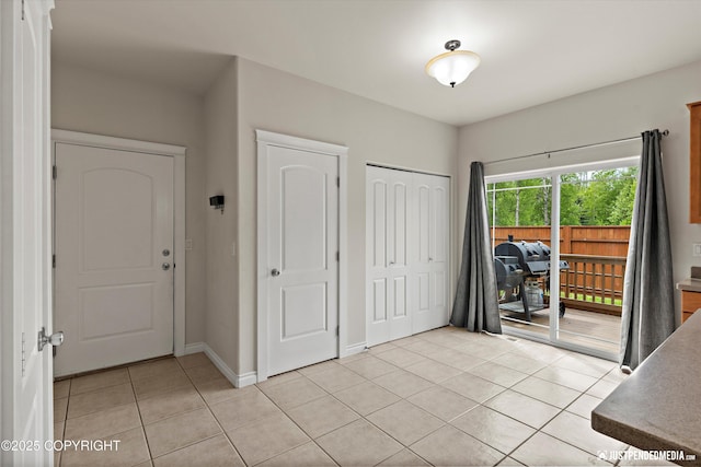 1675 E Pintail Dr, Wasilla, AK 99645 - entrance foyer featuring light tile patterned floors and baseboards