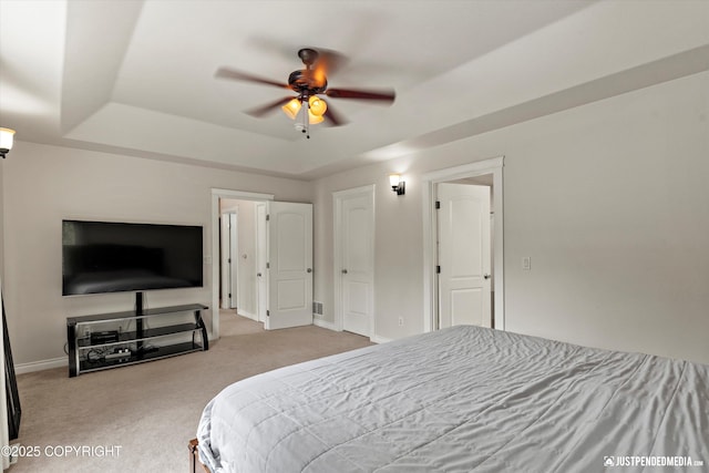 1675 E Pintail Dr, Wasilla, AK 99645 - bedroom featuring carpet flooring, baseboards, a tray ceiling, and a ceiling fan