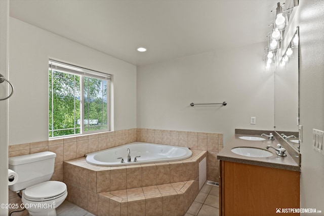 1675 E Pintail Dr, Wasilla, AK 99645 - bathroom featuring a garden tub, tile patterned floors, toilet, and double vanity