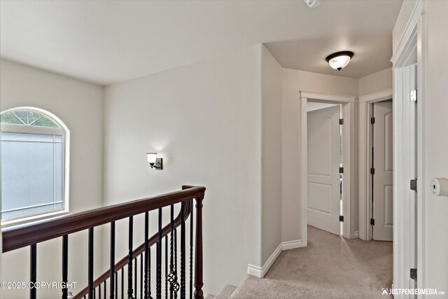 1675 E Pintail Dr, Wasilla, AK 99645 - hallway with an upstairs landing, light carpet, and baseboards