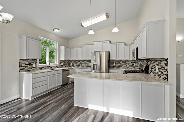 1130 W Granville St, Palmer, AK 99645 - kitchen with stainless steel appliances, a peninsula, lofted ceiling, decorative backsplash, and a sink