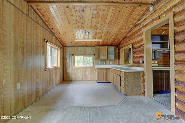 8301 W Lost Valley Rd, Wasilla, AK 99623 - kitchen with vaulted ceiling, light countertops, light carpet, wooden ceiling, and rustic walls