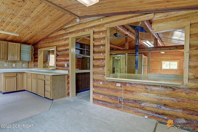 8301 W Lost Valley Rd, Wasilla, AK 99623 - kitchen featuring wooden ceiling, vaulted ceiling, carpet floors, rustic walls, and light countertops
