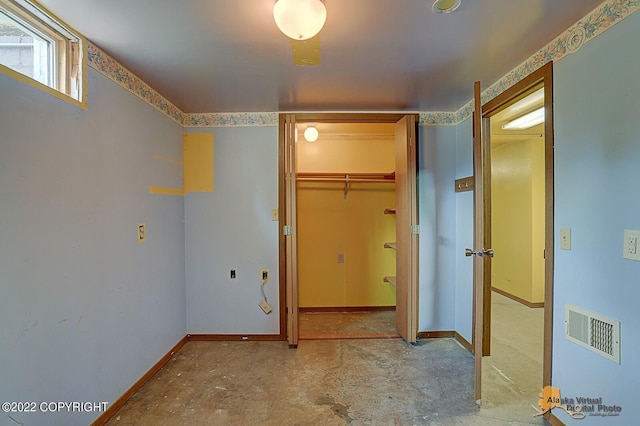 8301 W Lost Valley Rd, Wasilla, AK 99623 - unfurnished bedroom featuring baseboards, a spacious closet, and a closet