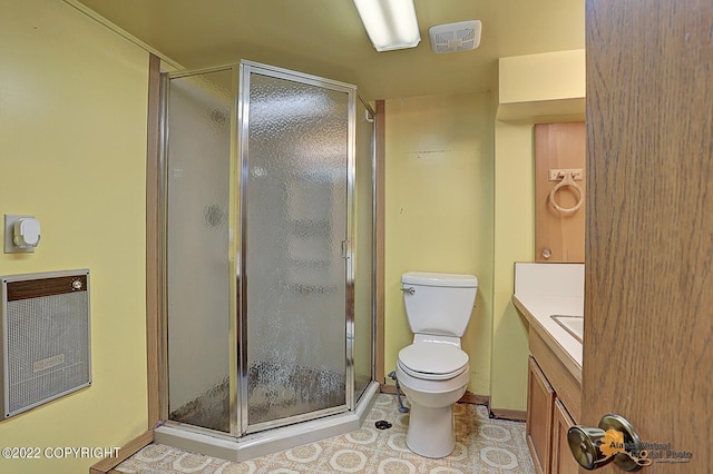 8301 W Lost Valley Rd, Wasilla, AK 99623 - bathroom with toilet, a shower stall, vanity, and tile patterned flooring