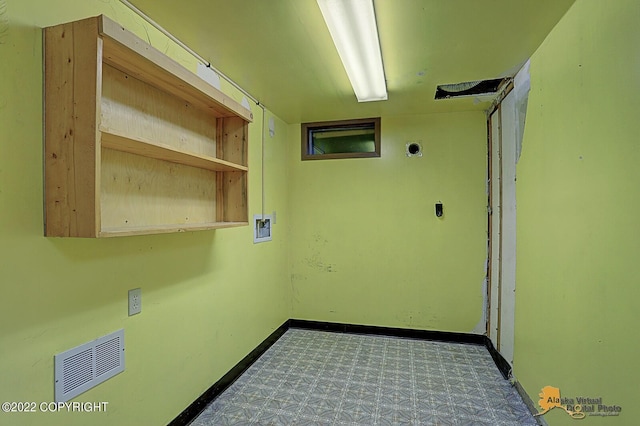 8301 W Lost Valley Rd, Wasilla, AK 99623 - laundry room featuring tile patterned floors, washer hookup, baseboards, and electric dryer hookup