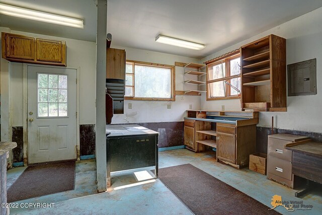 8301 W Lost Valley Rd, Wasilla, AK 99623 - kitchen with open shelves, healthy amount of natural light, electric panel, and brown cabinetry