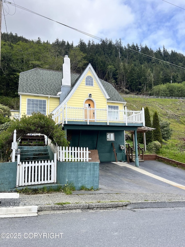 2030 2nd Ave Ave, Ketchikan, AK 99901 - view of front of property featuring a forest view, a chimney, and driveway