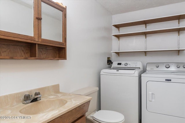 3432 Conifer Dr, North Pole, AK 99705 - bathroom with independent washer and dryer, toilet, vanity, and a textured ceiling