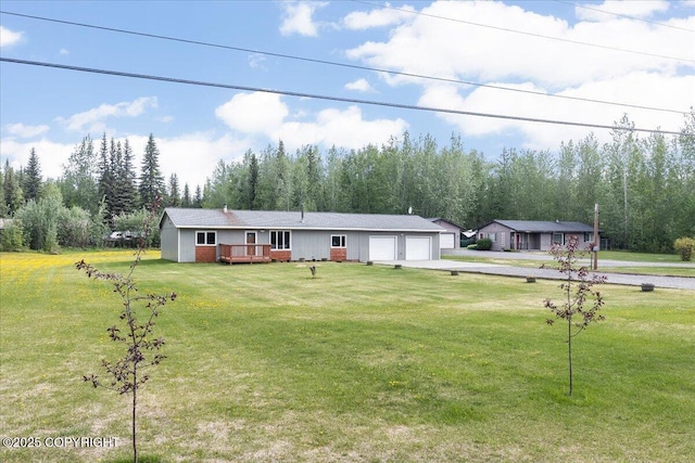 3432 Conifer Dr, North Pole, AK 99705 - ranch-style home with a wooden deck, a front lawn, a garage, and driveway