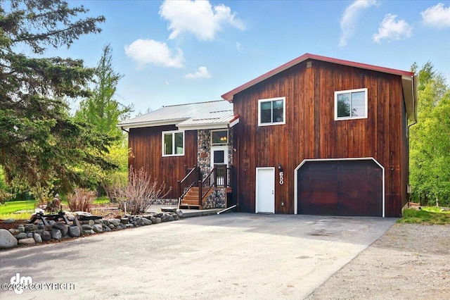 650 N Esty Dr, Palmer, AK 99645 - rustic home with a garage, metal roof, and concrete driveway
