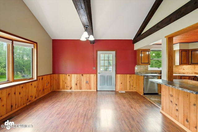 650 N Esty Dr, Palmer, AK 99645 - kitchen featuring stainless steel dishwasher, wood finished floors, wainscoting, decorative backsplash, and wood walls