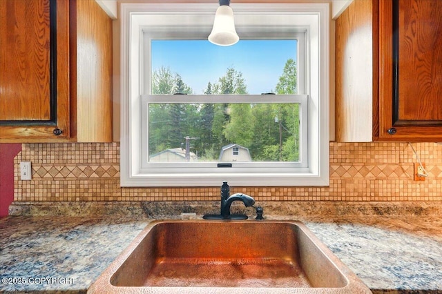 650 N Esty Dr, Palmer, AK 99645 - kitchen view of a sink, backsplash, stone counters, and brown cabinets