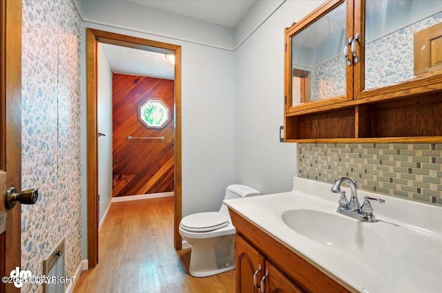 650 N Esty Dr, Palmer, AK 99645 - bathroom with toilet, wood finished floors, vanity, tasteful backsplash, and wood walls