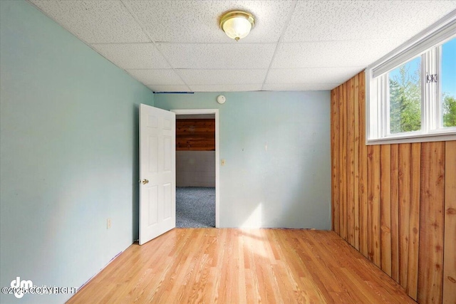 650 N Esty Dr, Palmer, AK 99645 - empty room with wood finished floors, a paneled ceiling, wood walls, and a smoke detector