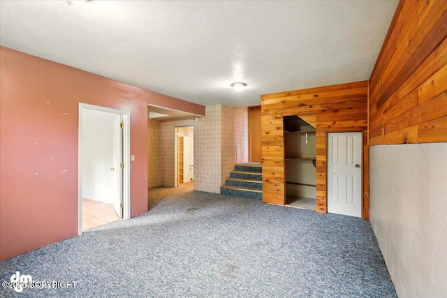 650 N Esty Dr, Palmer, AK 99645 - empty room with stairs, carpet flooring, wood walls, and a textured ceiling